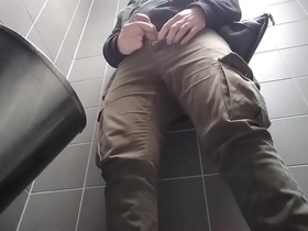 Young man with uncut dick peeing in a public urinal. He then shows and shakes his dick.